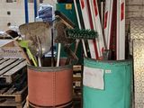 Plusieurs paires de skis et de bâtons de ski sont empilés dans un local de rangement