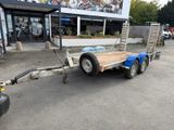 a trailer with a trailer attached to it in a parking lot