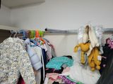 a closet full of clothes and clothes hanging on a rail
