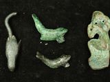 several pieces of ancient artifacts are displayed on a black surface