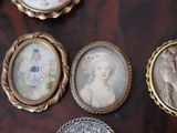 five miniature pictures of a woman and a man on a table