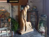 a statue of a woman and a dog on a table