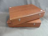 two wooden boxes are stacked on top of each other on a gray background