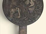 a mirror with a picture of a man on a horse on it