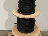 a close up of a stack of black and blue wires on a wooden stand