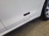 a close up of a car ' s tire on the side of the road