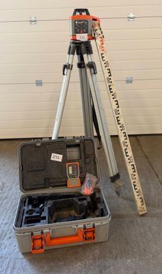 a tripod and a tool case in a garage