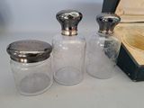 three glass jars sitting on a table next to a box