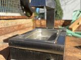 a small stove that is sitting on a wooden table