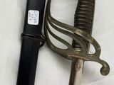 a sword and a lighter on a white surface
