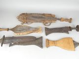 several pieces of wood and metal are displayed on a white surface