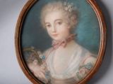 portrait of a woman in a white dress holding a basket of flowers