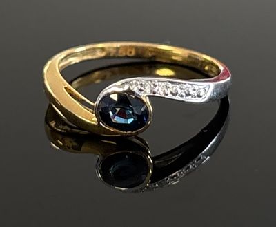 an image of a gold ring with a blue stone and diamonds
