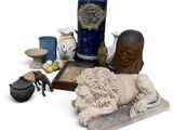 a statue of a man laying on a table next to other items