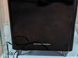 a black microwave sitting in a glass box on the floor