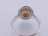 a close up of a ring with a yellow diamond in it