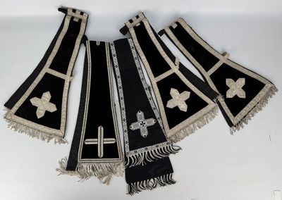 three black and white stoles with crosses and crosses on them