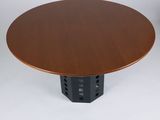 a round wooden table with a metal base and a wooden top