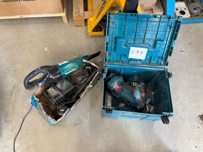 a blue tool box with tools inside of it on the floor