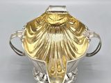 an image of a silver and gold plated bowl on a white surface