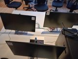 two computer monitors sitting on top of a desk