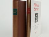 two books sitting on top of each other on a white surface