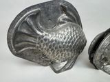 two metal objects that are sitting next to each other