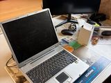a laptop computer sitting on top of a desk next to a computer monitor