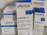 trois boîtes de crème Urage Xenose C posées sur une table