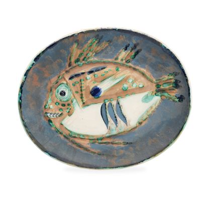 a plate with a fish design on it on a white background