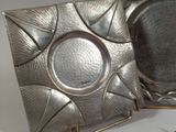a silver plate with a flower design on it
