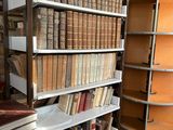 books are stacked on a shelf in a room with a lot of books on it