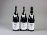 trois bouteilles de vin posées sur une table l'une à côté de l'autre