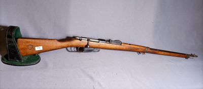 an old rifle with a wooden barrel on a white background