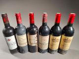 six bottles of wine are lined up in a row on a table