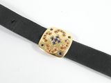 black leather belt with a gold buckle and blue and red flowers