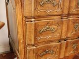 a dresser with a mirror on top of it in a room