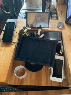 a man standing in front of a desk with a laptop and a monitor on it