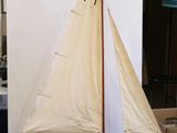 a model sailboat sitting on a table in a room