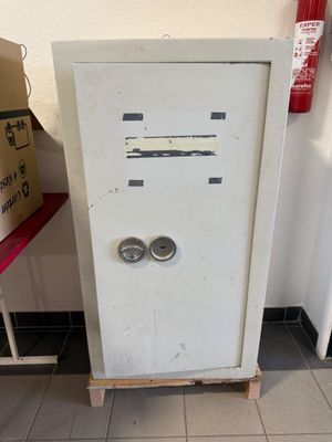 a white cabinet with two doors and a pair of eyes on it