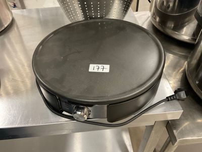 a large frying pan sitting on a table in a kitchen