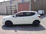 a picture of a white car parked in front of a building