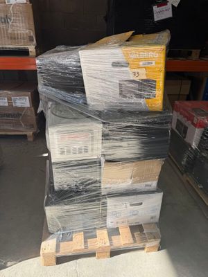 a large stack of boxes and pallets in a warehouse