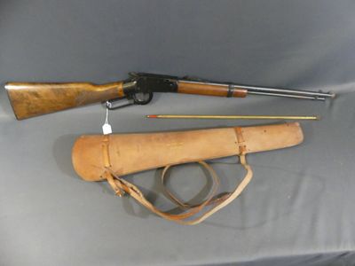 an old rifle and a gun are on a table