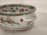 a white bowl with a design on it sitting on a table