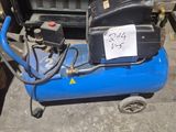 a blue air compressor sitting on top of a blue cart