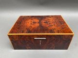 a wooden box with a lock on top of it