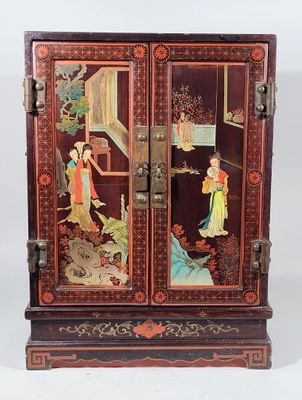 a wooden cabinet with a painting on it