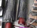 three umbrellas that are wrapped in plastic on a table