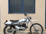 a white motorcycle parked in front of a building